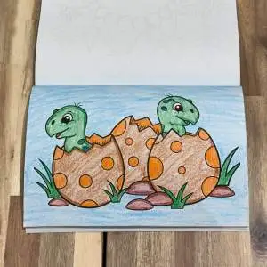 Dinosaur coloring book page of 2 dinosaurs with broken eggs